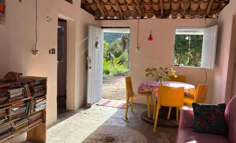 Traditional house in front of the Fundão Waterfall